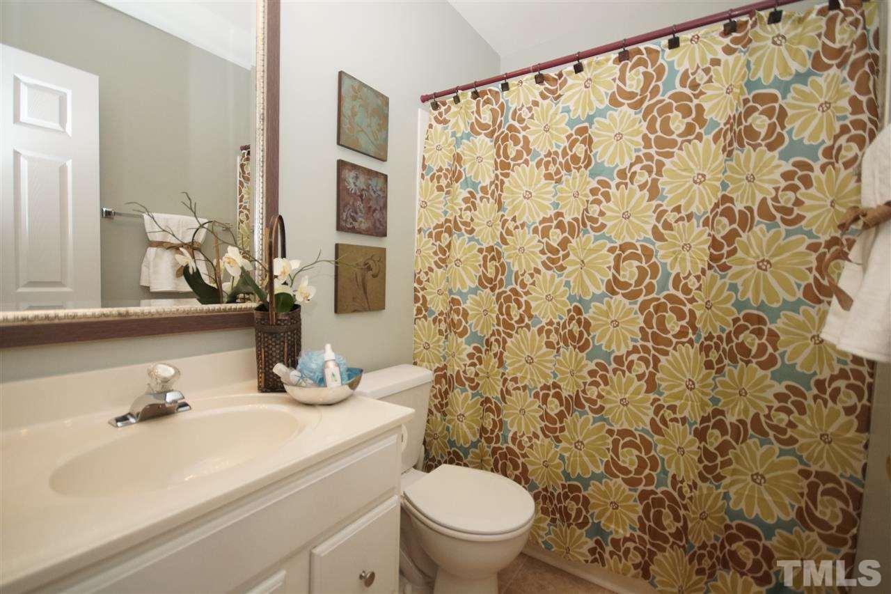 5202 Echo Ridge Road Raleigh, NC 27612 - Photo 17 of 22 a bathroom with a sink toilet and mirror