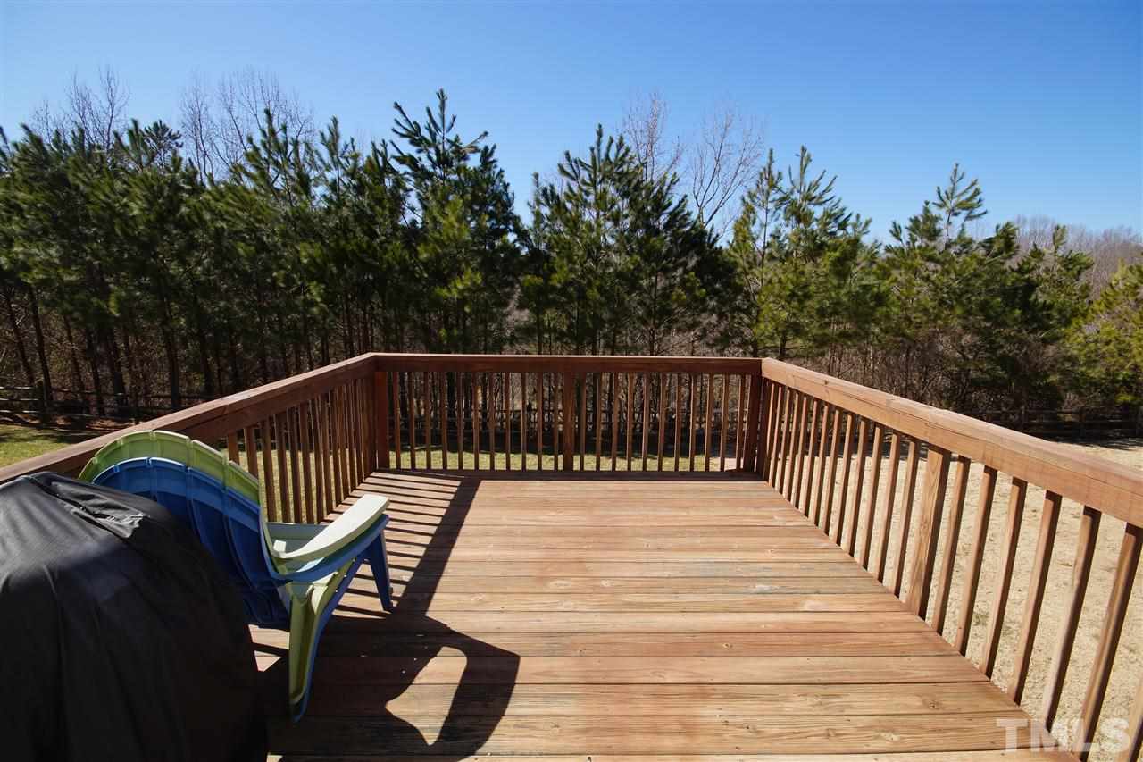 5202 Echo Ridge Road Raleigh, NC 27612 - Photo 19 of 22 a roof deck with wooden floor and fence