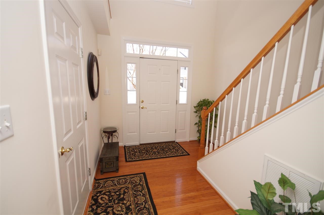 5202 Echo Ridge Road Raleigh, NC 27612 - Photo 3 of 22 a view of a hallway with wooden floor and staircase