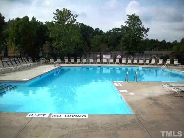 5202 Echo Ridge Road Raleigh, NC 27612 - Photo 22 of 22 a view of a swimming pool with a yard and plants