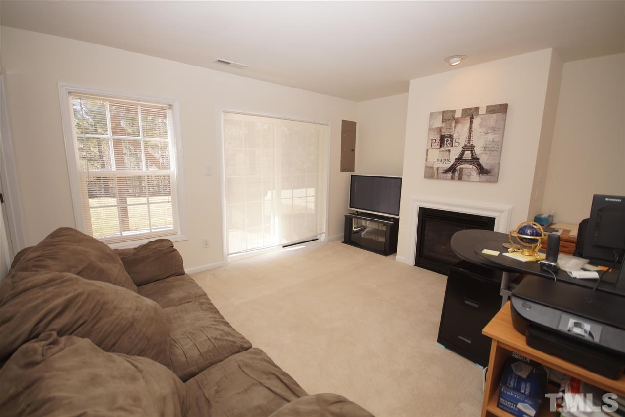 5202 Echo Ridge Road Raleigh, NC 27612 - Photo 4 of 22 a living room with furniture a fireplace and a window