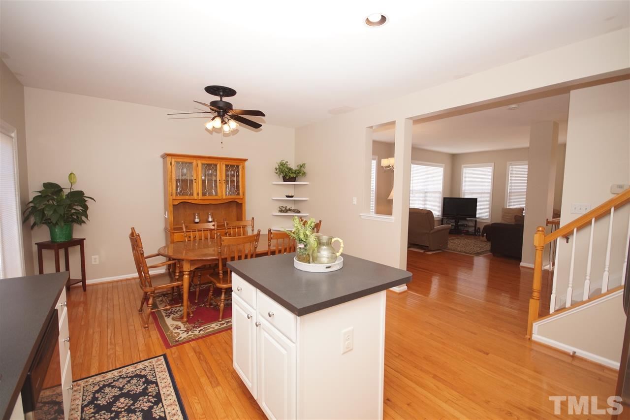 5202 Echo Ridge Road Raleigh, NC 27612 - Photo 9 of 22 a living room with granite countertop furniture a dining table with wooden floor