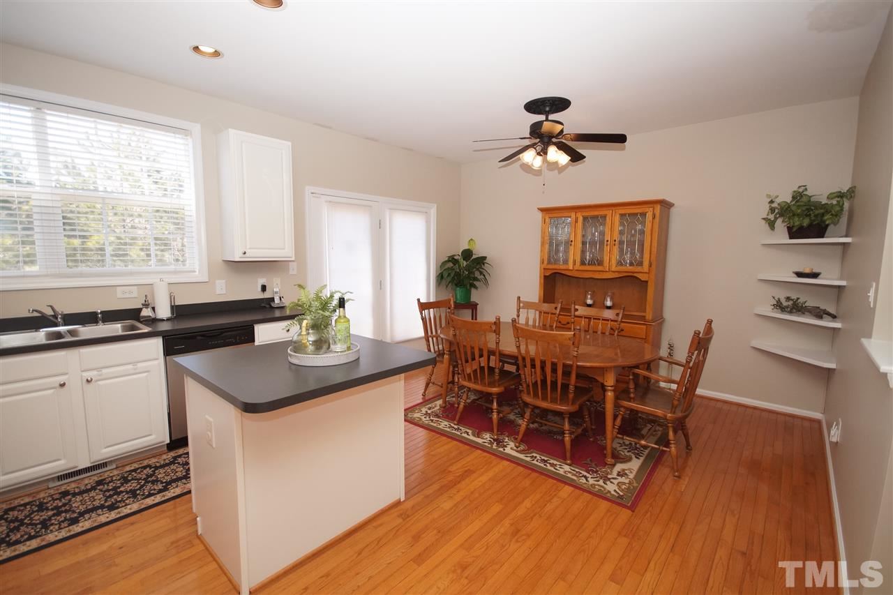 5202 Echo Ridge Road Raleigh, NC 27612 - Photo 10 of 22 a view of a dining room with furniture window and wooden floor