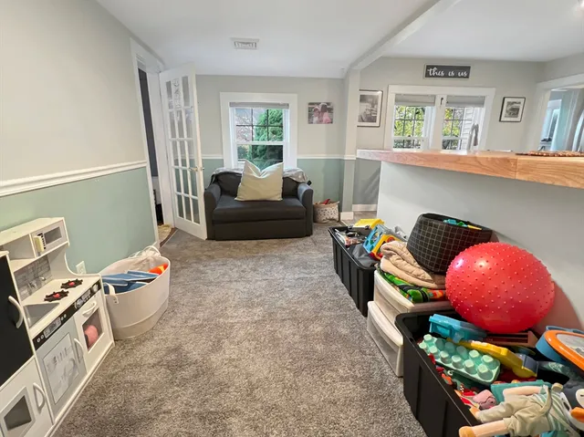 a living room with furniture and a floor to ceiling window