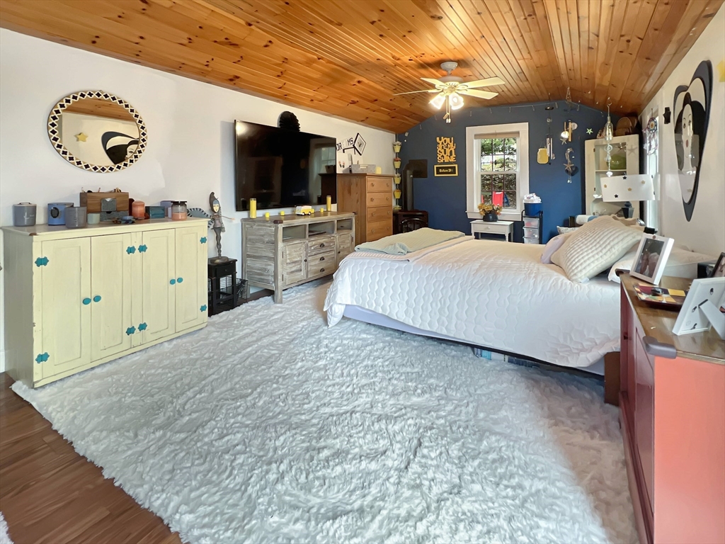 1649 Washington Street Canton, MA 02021 - Photo 17 of 38 a spacious bedroom with a bed and a flat tv screen on dresser