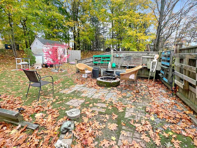 a bedroom with a bed a mirror and dresser