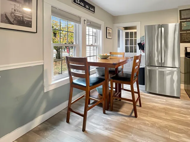 a dining room with furniture and window