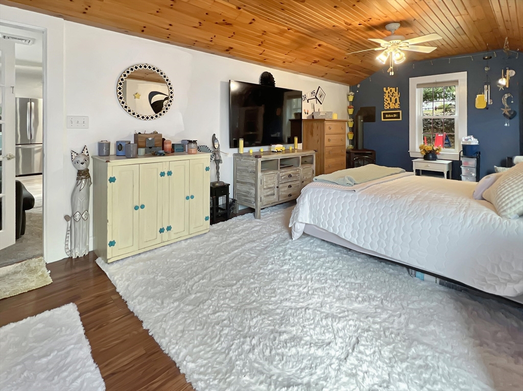 1649 Washington Street Canton, MA 02021 - Photo 21 of 38 a spacious bedroom with a bed and a flat tv screen on dresser