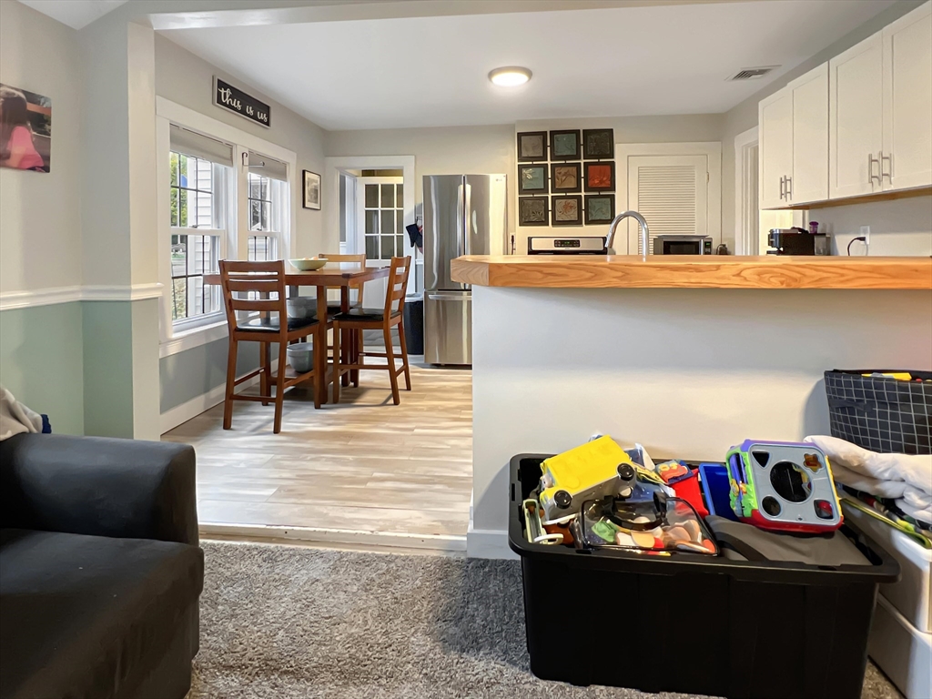 1649 Washington Street Canton, MA 02021 - Photo 21 of 38 a living room with furniture and kitchen view