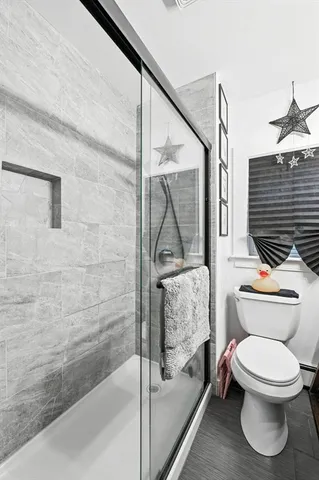 a bathroom with a toilet sink and mirror