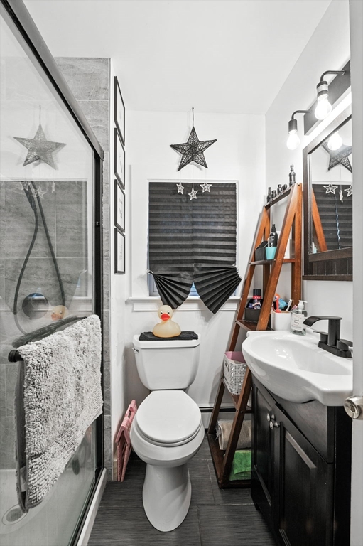 1649 Washington Street Canton, MA 02021 - Photo 27 of 38 a bathroom with a toilet sink and mirror
