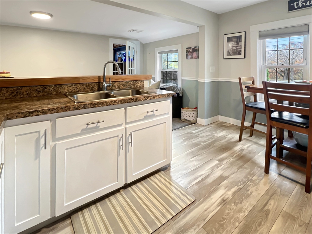 1649 Washington Street Canton, MA 02021 - Photo 7 of 38 a kitchen with granite countertop white cabinets and white appliances