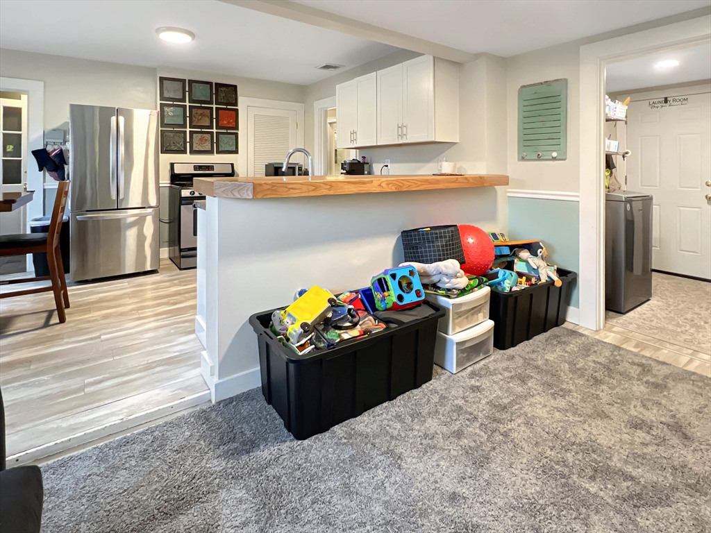 1649 Washington Street Canton, MA 02021 - Photo 8 of 38 a kitchen with a refrigerator and a stove top oven