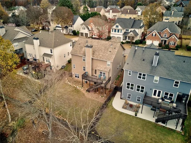 an empty room with windows fireplace and a sink