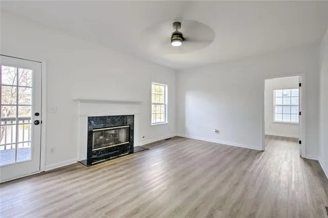 a view of an empty room with cabinet and a window