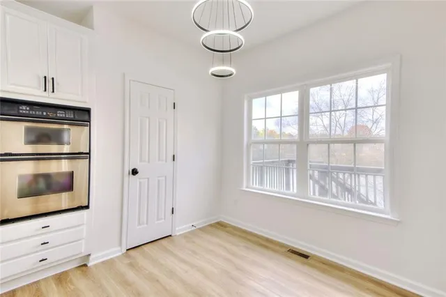 a white bath tub sitting in a bathroom next to a window