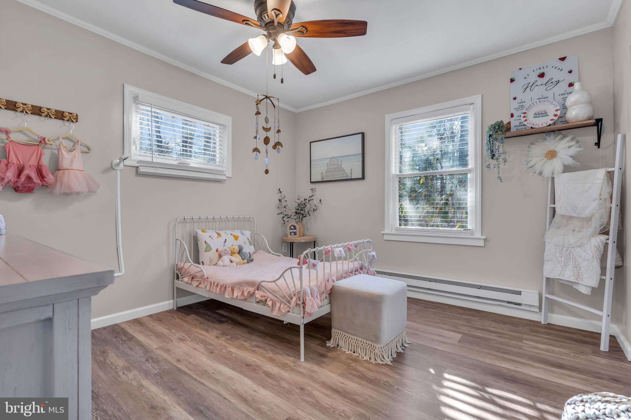 116 Polly Pod Road West Creek, NJ 08092 - Photo 14 of 33 a bedroom with a bed and a chandelier