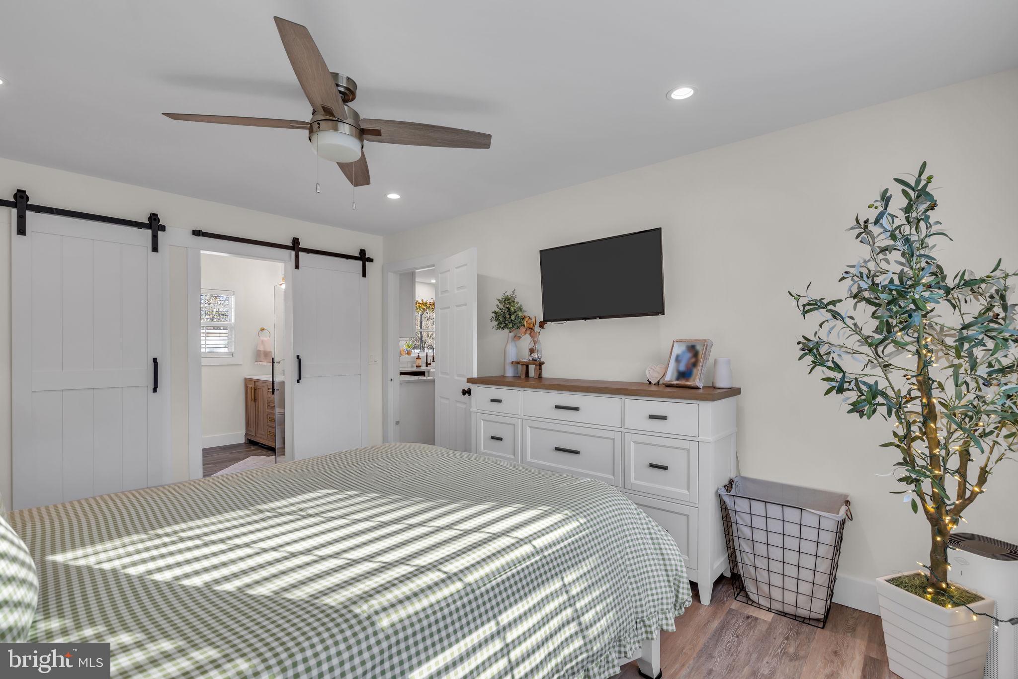 116 Polly Pod Road West Creek, NJ 08092 - Photo 17 of 33 a bedroom with a bed and a chandelier