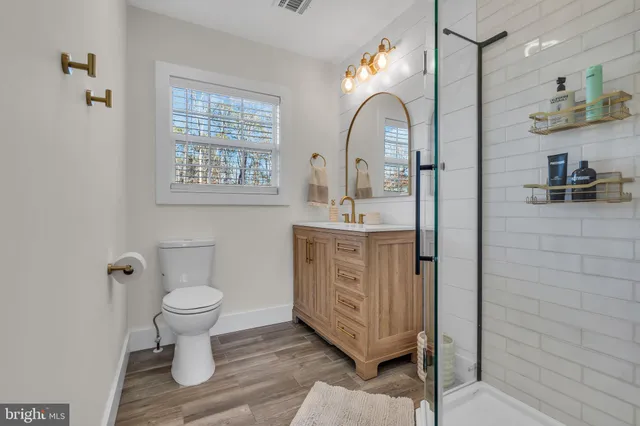 a bathroom with a sink a toilet and a mirror