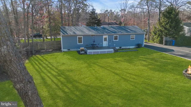 a view of a house with pool and a yard