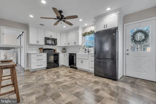 a kitchen with stainless steel appliances a refrigerator sink and microwave