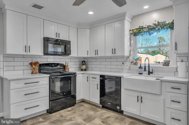 a kitchen with cabinets stainless steel appliances and sink