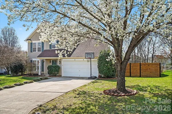a front view of house with yard and trees
