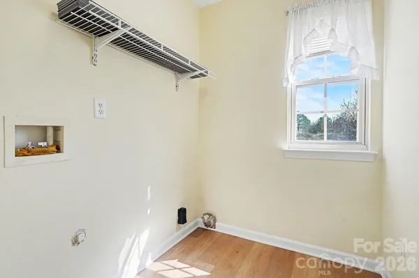 a view of a livingroom with wooden floor and a window