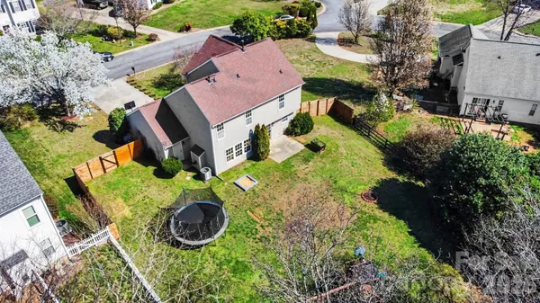 an aerial view of a house with garden space and street view