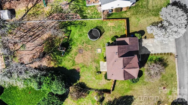 an aerial view of house with yard swimming pool and outdoor seating