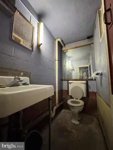 a kitchen that has a table chairs and a refrigerator