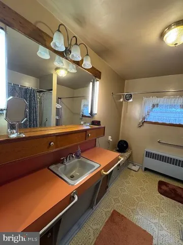 a bathroom with a tub sink and mirror