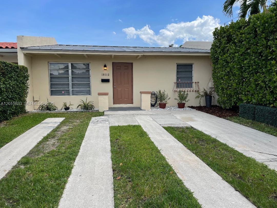 10112 Southwest 20th Street Miami, FL 33165 - Photo 1 of 10 a front view of a house with a yard