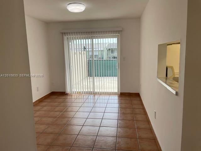 10112 Southwest 20th Street Miami, FL 33165 - Photo 6 of 10 a view of an empty room with a window