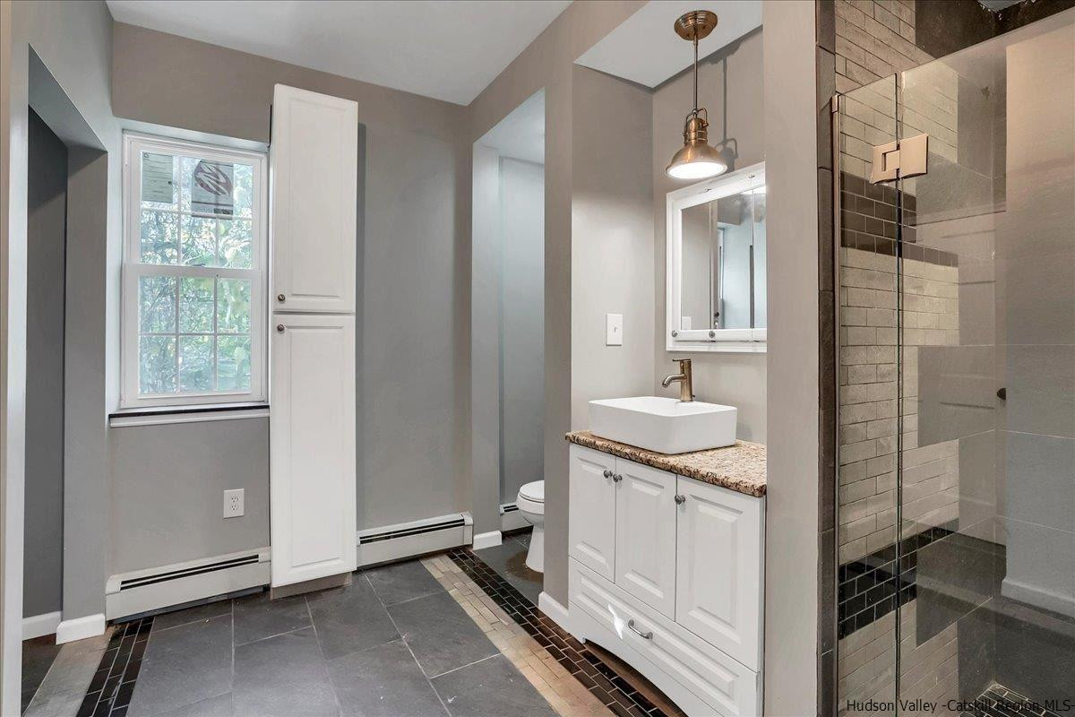 57 Tow Path Wawarsing, NY 12489 - Photo 14 of 28 a bathroom with a sink a toilet and shower