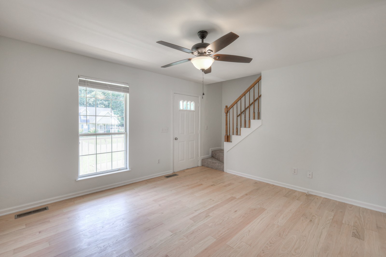 7195 Chester Road Fairview, TN 37062 - Photo 16 of 32 an empty room with wooden floor fan and windows