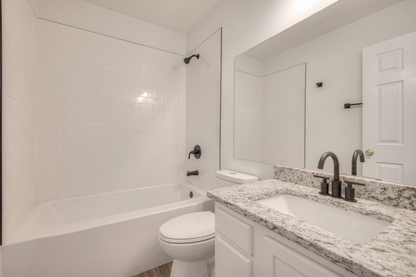 7195 Chester Road Fairview, TN 37062 - Photo 27 of 32 a bathroom with a granite countertop sink a toilet and bathtub