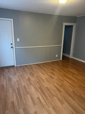 an empty room with wooden floor