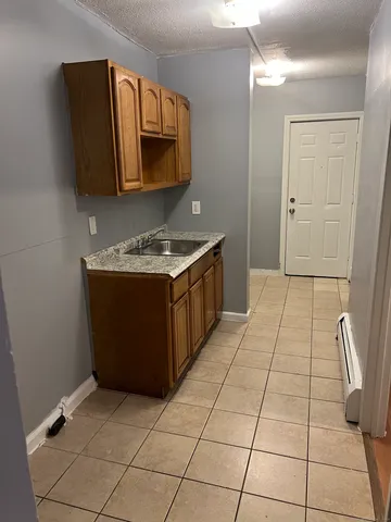 a kitchen with a sink a stove and cabinets