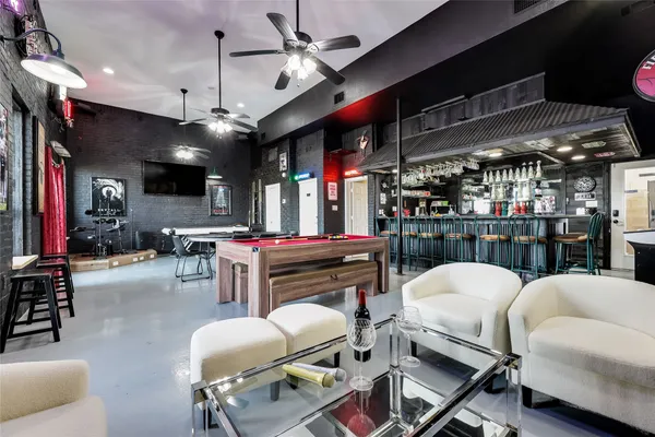 a room with stainless steel appliances kitchen island granite countertop furniture and a view of kitchen