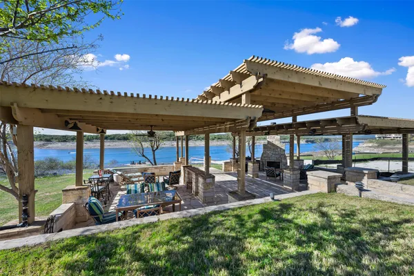 a view of a patio with table and chairs under an umbrella with a patio