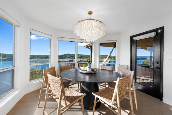a view of a dining room with furniture wooden floor and chandelier