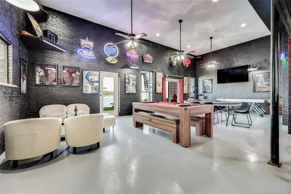 a room with pool table table and chairs
