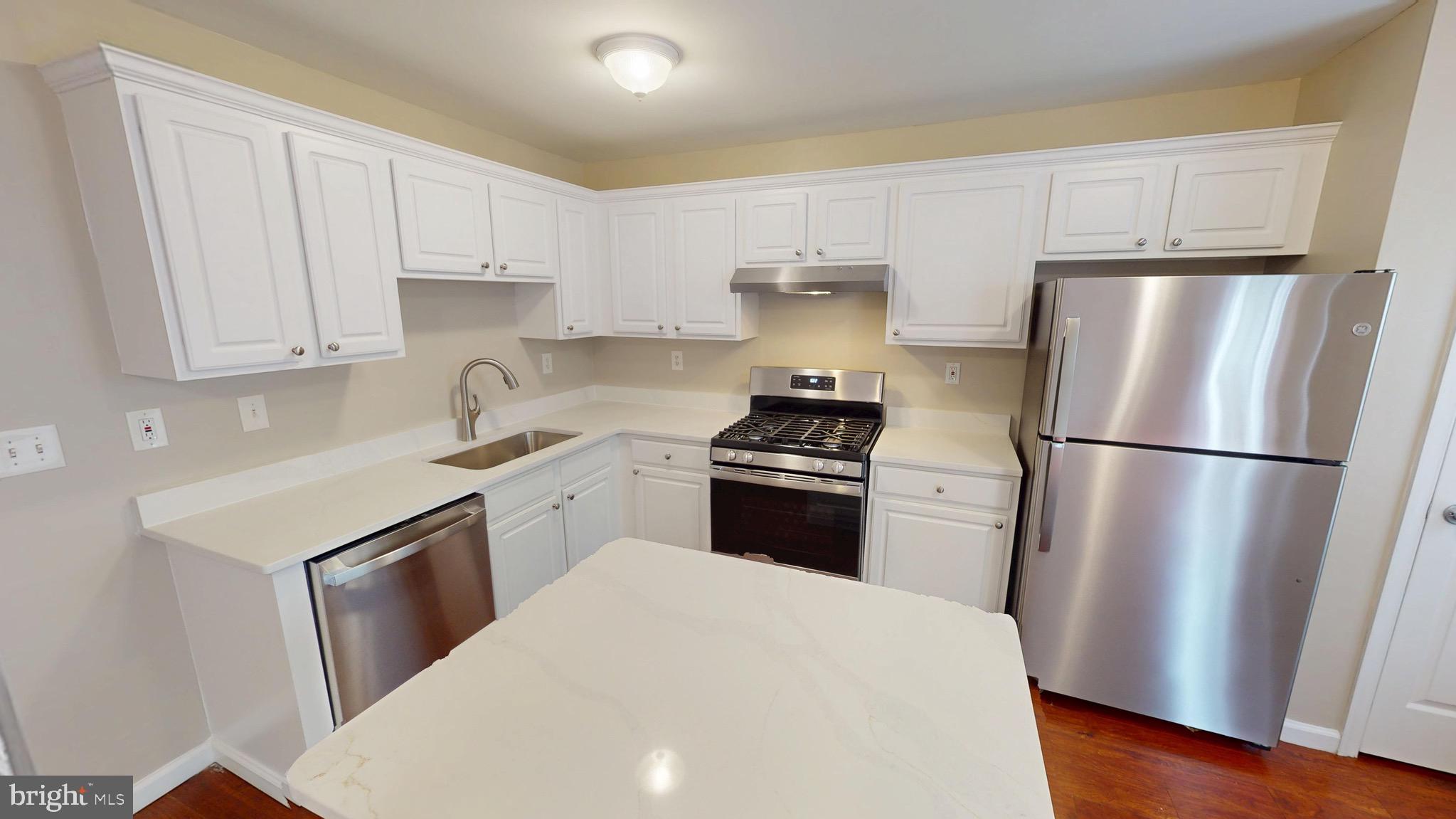 10611 Riva Place White Plains, MD 20695 - Photo 24 of 93 a kitchen with a refrigerator sink stove and cabinets