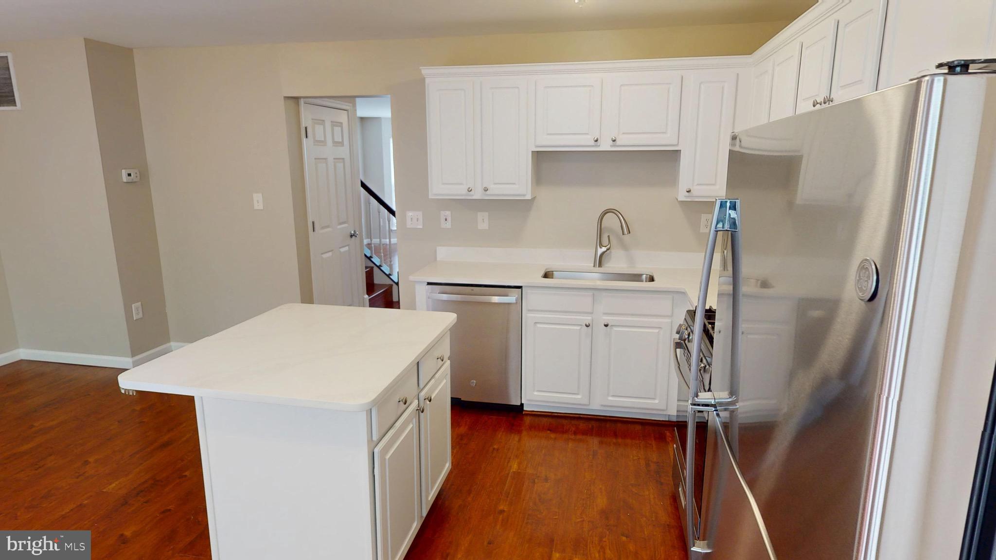 10611 Riva Place White Plains, MD 20695 - Photo 29 of 93 a kitchen with a sink a refrigerator a washer and dryer
