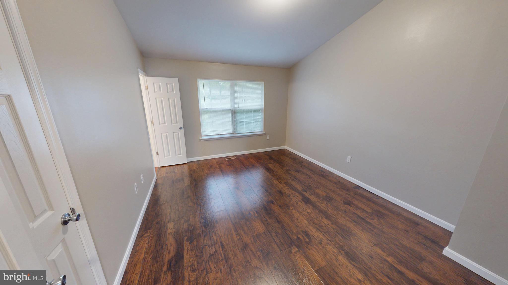 10611 Riva Place White Plains, MD 20695 - Photo 34 of 93 an empty room with wooden floor and windows