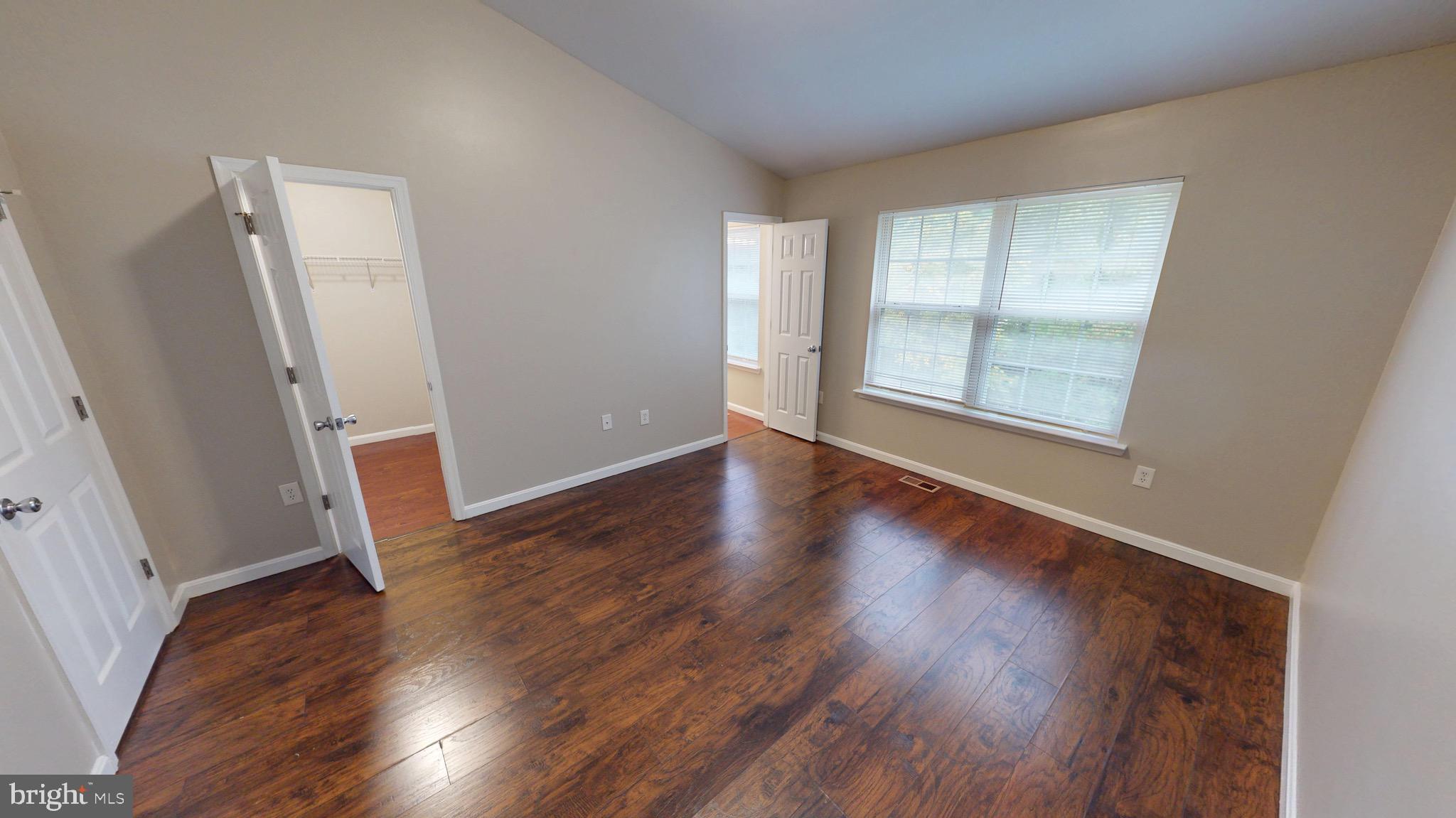 10611 Riva Place White Plains, MD 20695 - Photo 36 of 93 an empty room with wooden floor and windows