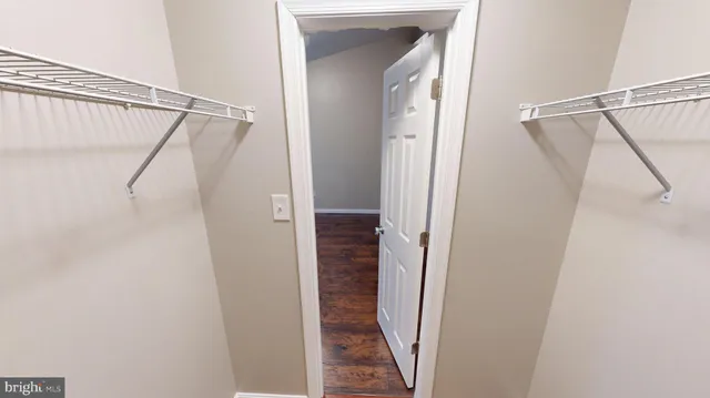 an empty room with wooden floor and fireplace