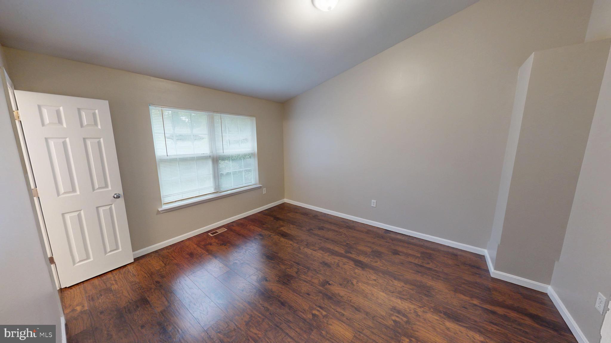 10611 Riva Place White Plains, MD 20695 - Photo 39 of 93 an empty room with wooden floor and windows