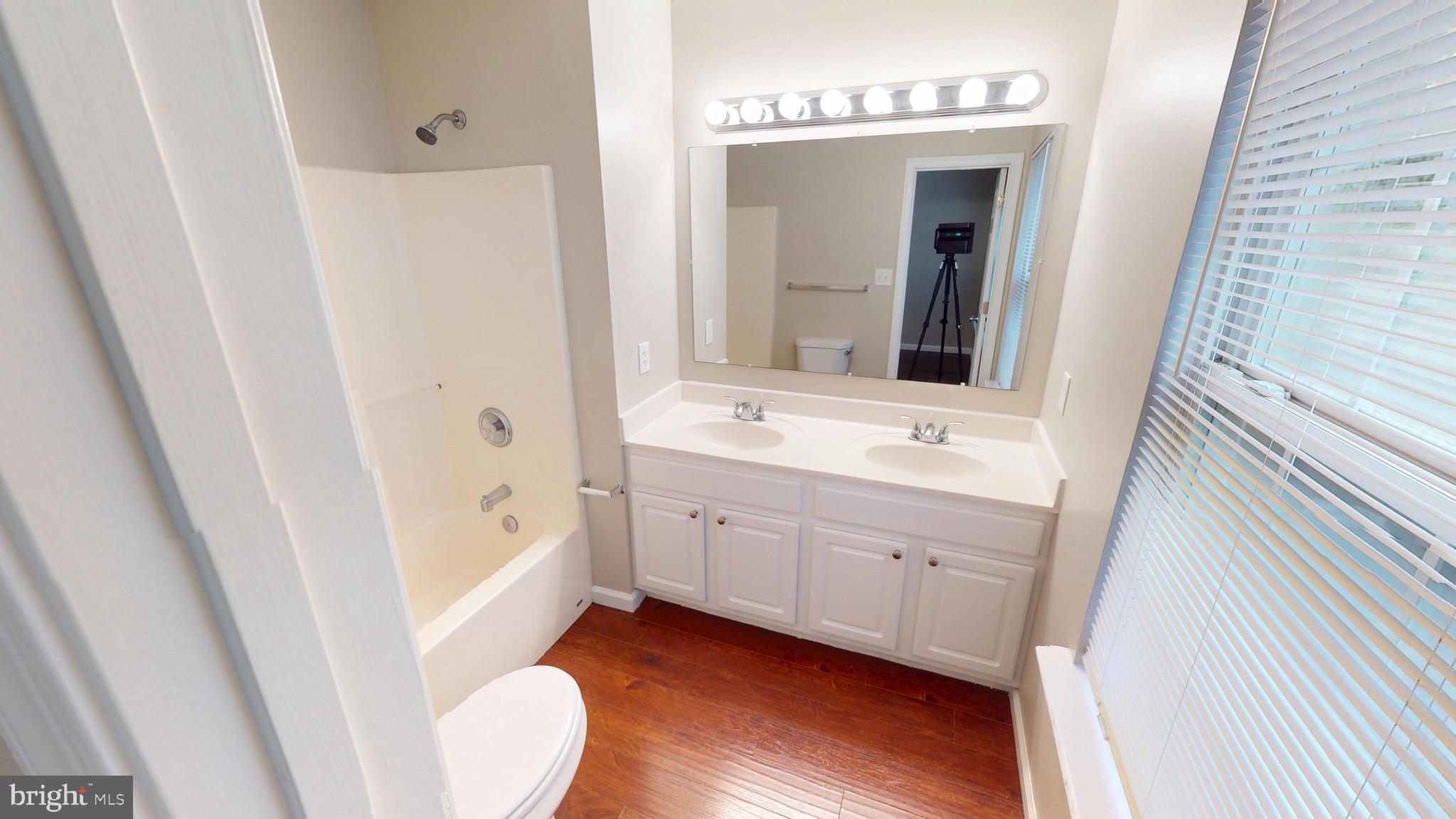 10611 Riva Place White Plains, MD 20695 - Photo 41 of 93 a bathroom with a sink a mirror and a bathtub